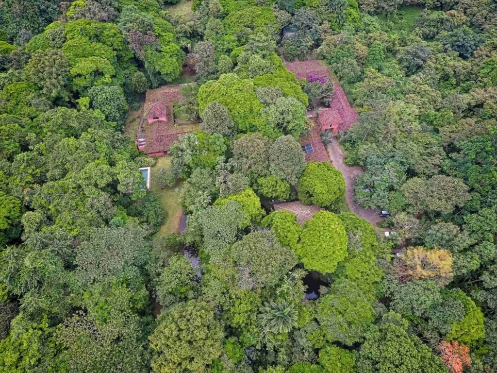 Aerial view of Hacienda La Isla buildings surrounded by tropical forest.