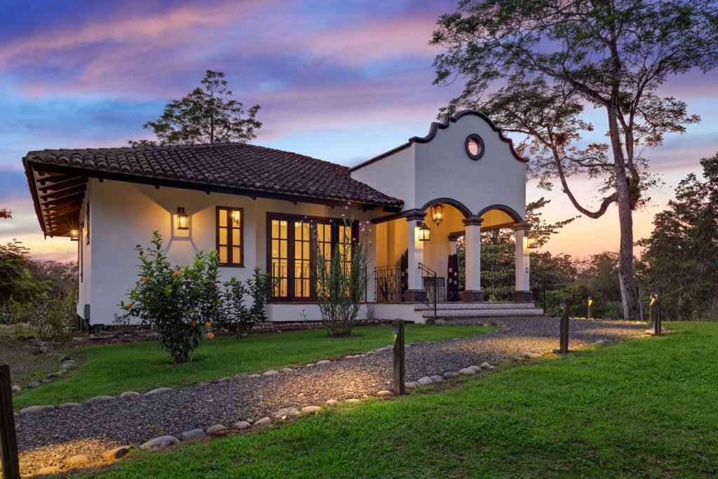 El Lugar Resort casita at sunset, surrounded by tropical gardens.