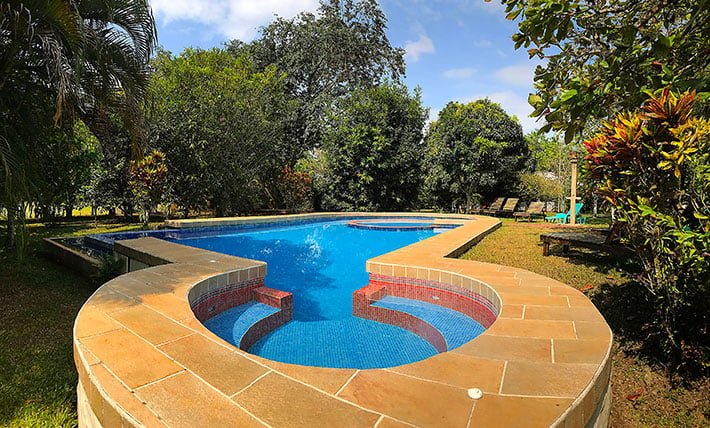 Swimming pool and tropical gardens at Hotel de Campo, Caño Negro, Costa Rica.